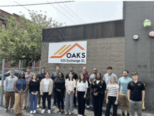 A group of people standing together. They appear to be outside.