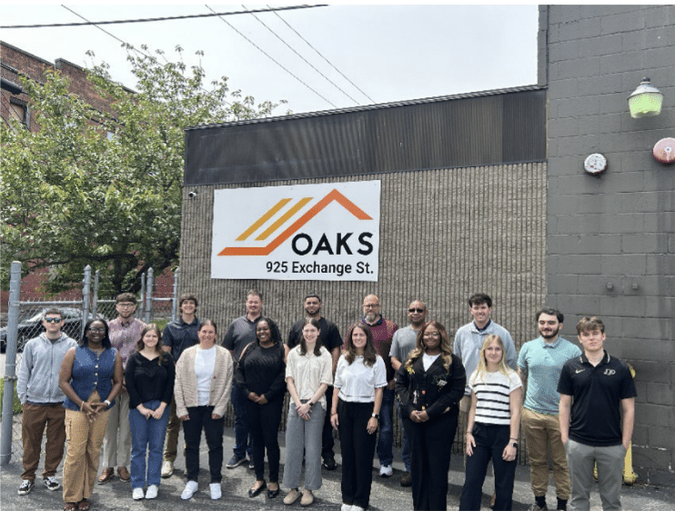 A group of people standing together. They appear to be outside.