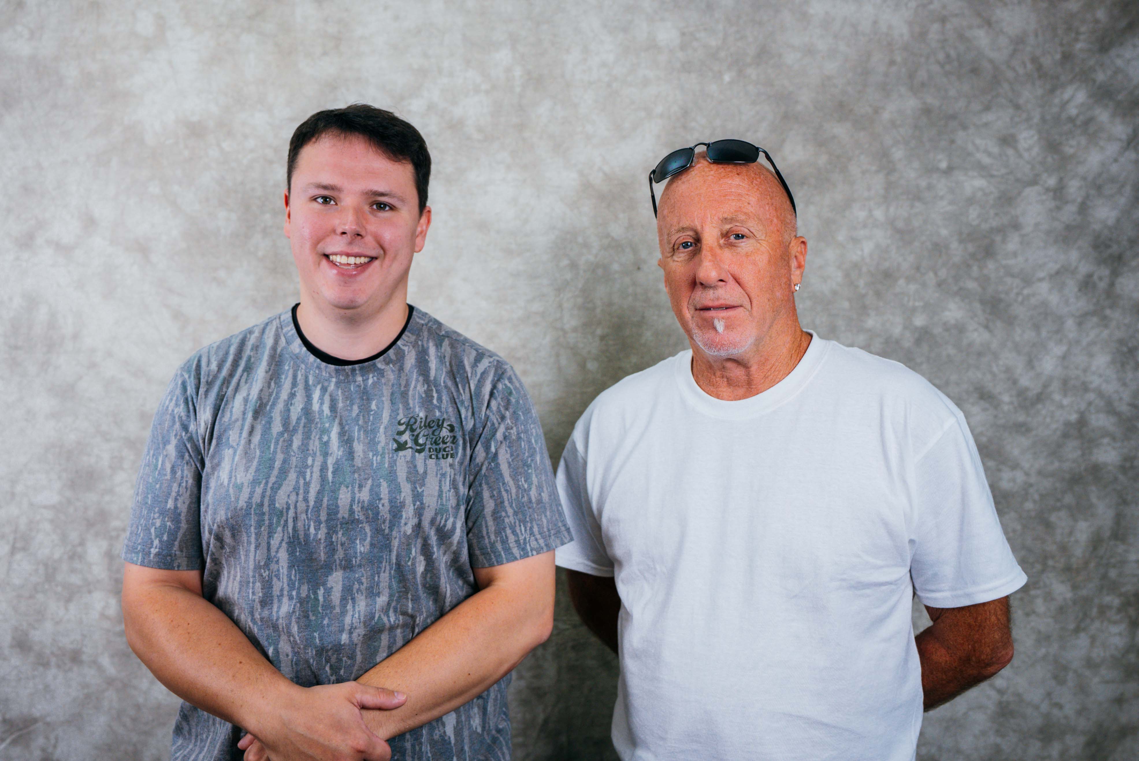 A young man and an older man standing together