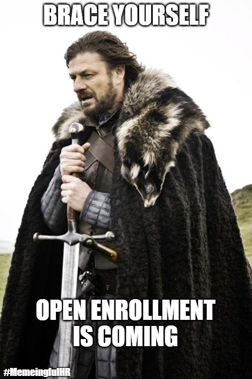 A meme featuring a man in a fur-trimmed cloak holding a sword, with the text 'Brace Yourself, Open Enrollment Is Coming.'
