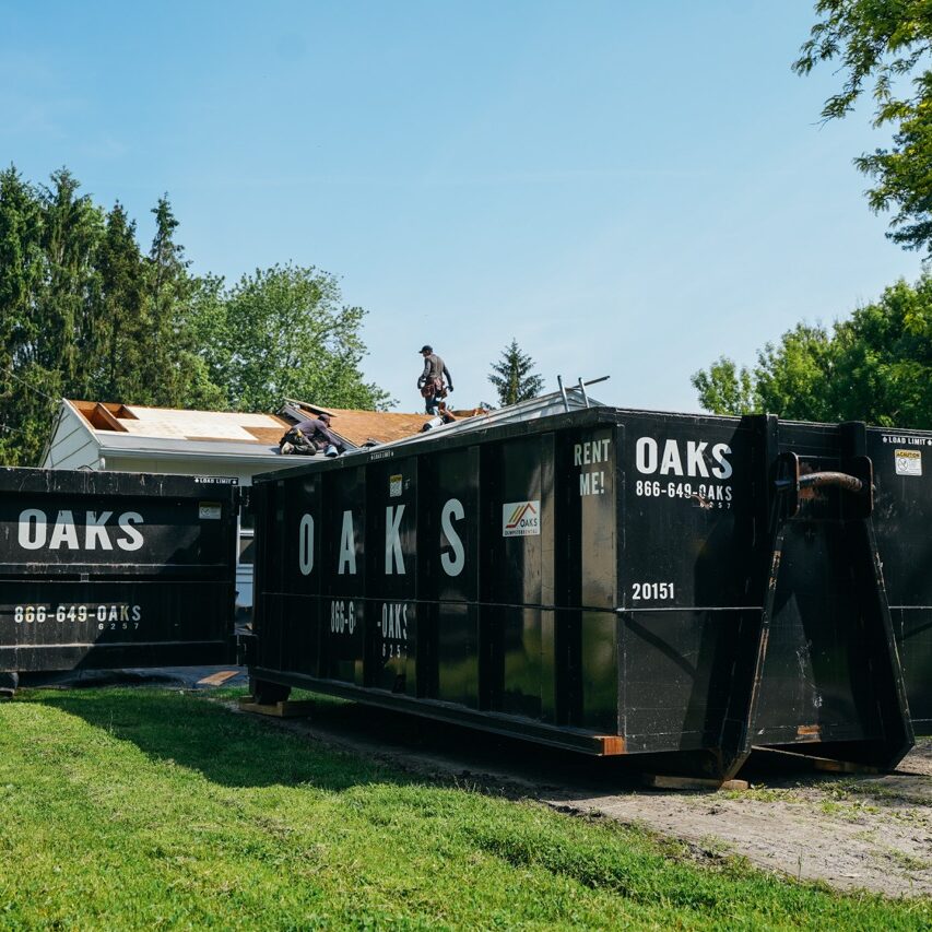 a man on a roof with Oaks storage containers